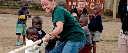 Projects Abroad volunteers work with children in Ghana. Childcare volunteer plays a game with children during her work experience in Ghana.